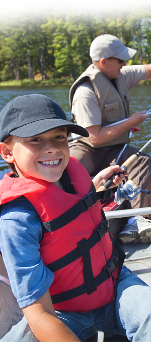 Child and grandpa in a boat fishing